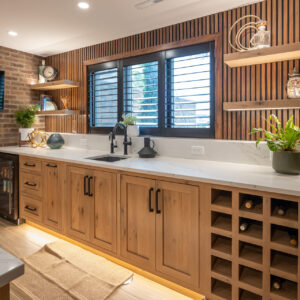 Stylish basement kitchen with light cabinetry, a large island, and modern fixtures.